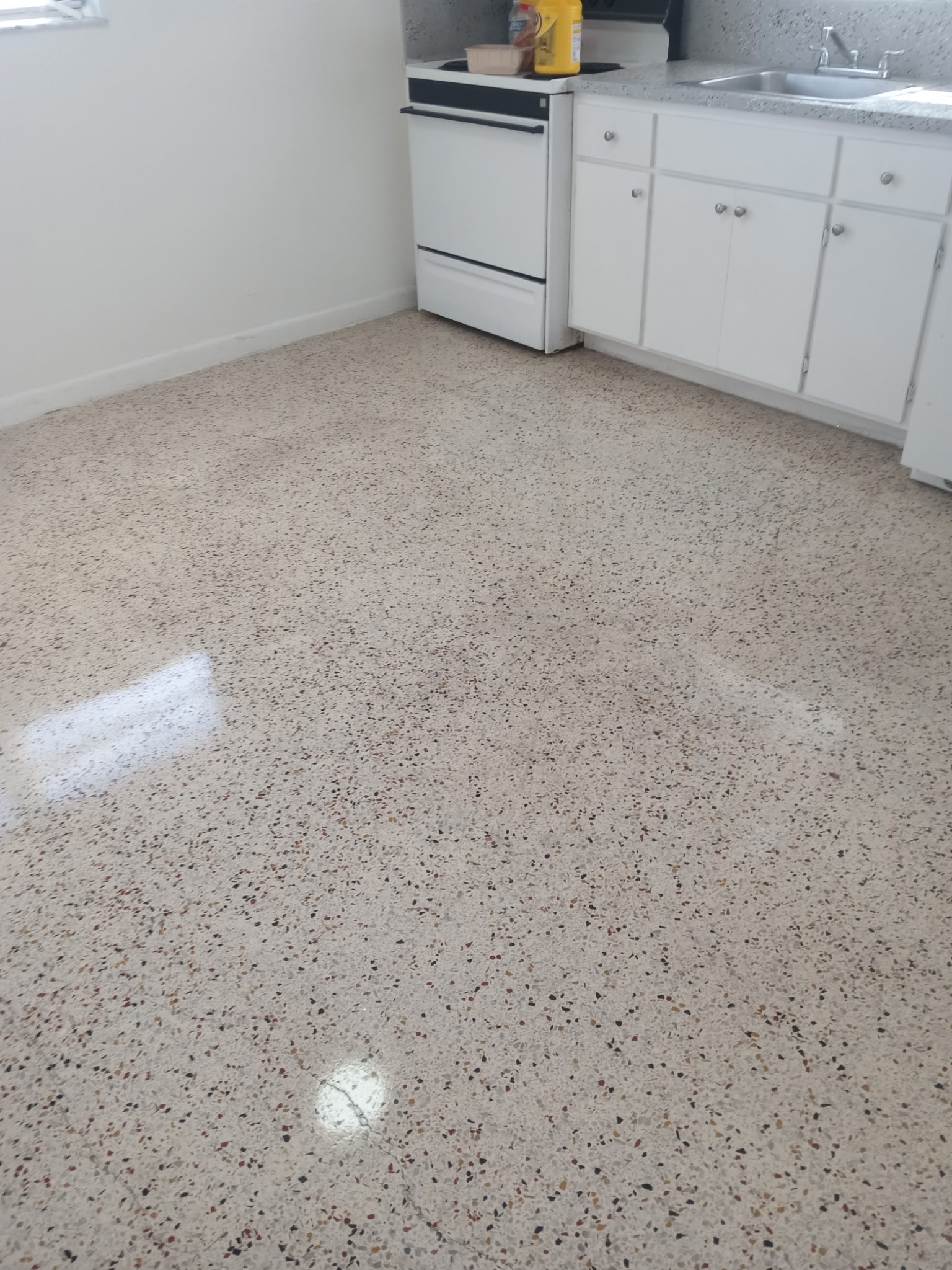 Clean polished terrazzo floor in an apartment kitchen